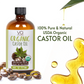 Bottle of Organic Castor Oil with label, castor beans, and oil droplets on a white background