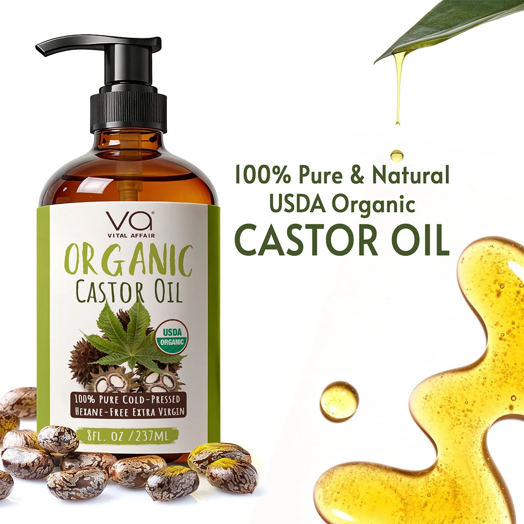Bottle of Vital Affair Organic Castor Oil with pump, surrounded by castor beans and oil droplets on a white background.