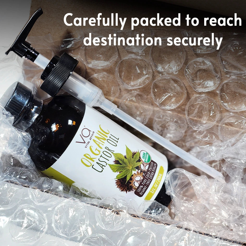 Vital Affair Organic Coconut Oil bottle with packaging on a cardboard surface, text 'Carefully packed to reach destination securely'.
